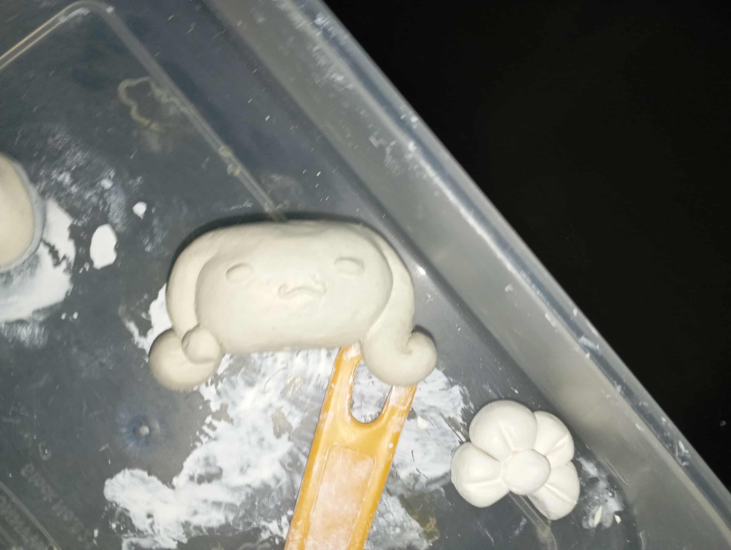 A cinnamonroll diy air-dry clay figurine! it's still drying in this picture so it feels a bit moist, the clay's smell isn't great, it smells like glue, but it's not that bad, so i guess it's fine!