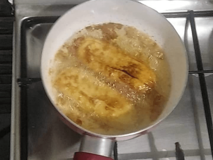 banana cue frying on a pan, banana cue is a sweet snack originating from the philippines, it is made up of fried saba (a type of banana) which is coated in sugar